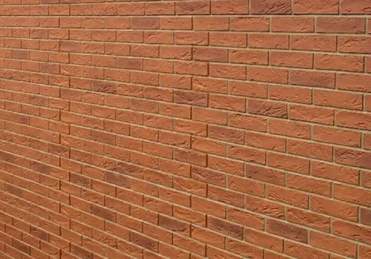 BRIXK-CLADS - All Seasons Steel Buildings Close-up of a red brick wall with horizontal mortar joints.