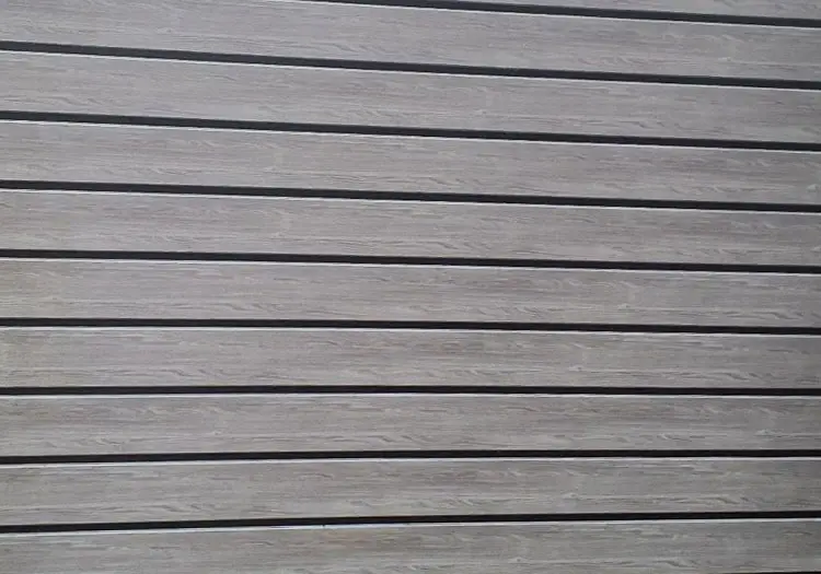 PLANK-CLAD - All Seasons Steel Buildings Wooden deck or plank flooring with evenly spaced dark gaps between light brown boards.