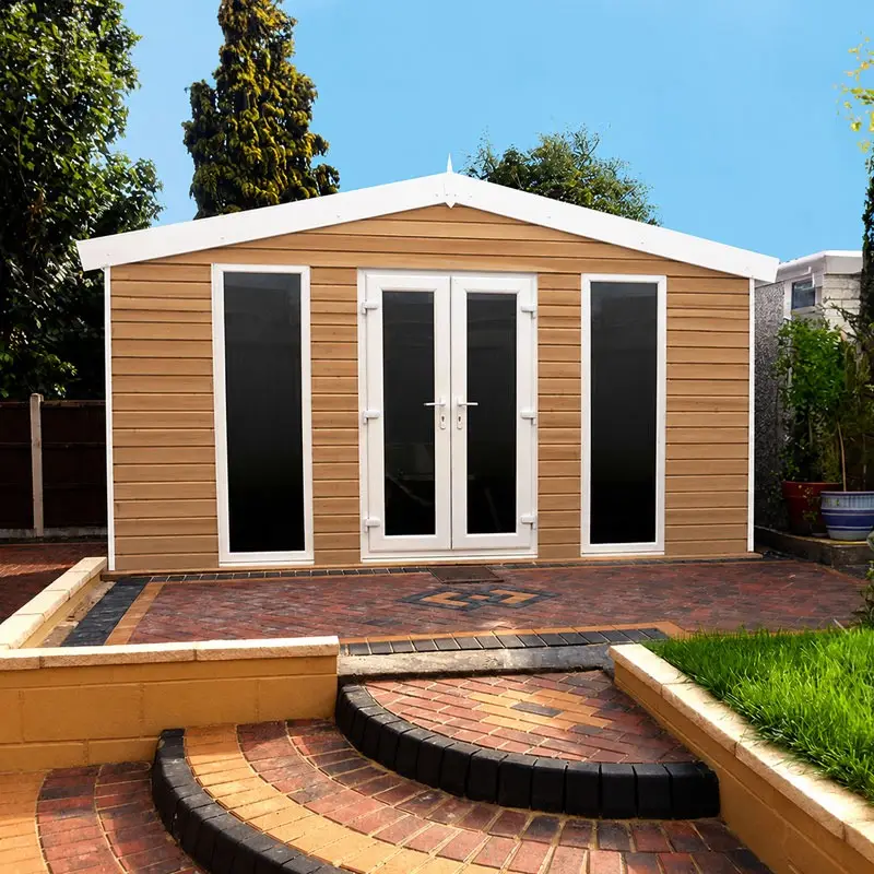 Wood-clad garden shed with white-framed glass doors on a brick patio, in a sunny backyard.