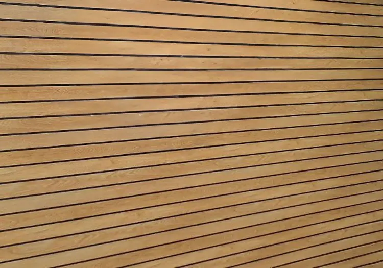 WOOD-CLAD - All Seasons Steel Buildings Close-up of light wooden planks with evenly spaced dark grooves running horizontally across the surface.